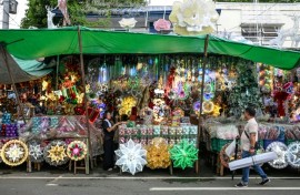 A man walks past Christmas decorations at a market in Quezon City, Metro Manila