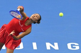 China’s Zheng Qinwen serves to Russia’s Mirra Andreeva
