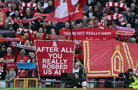Liverpool fans hold signs mocking Manchester City's financial scandal