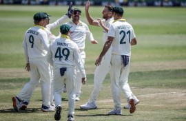 Australia's Josh Hazlewood (2nd R) celebrates taking Wiaan Mulder's wicket on day five