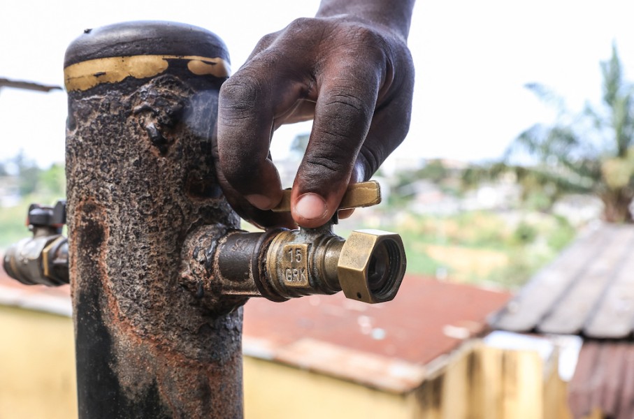 A person opens the tap. AFP