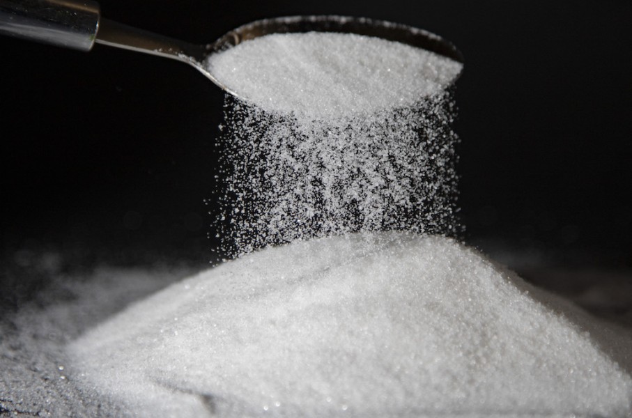 File: A person dumps sugar onto a table with a spoon. AFP/Thibaut Durand/Hans Lucas