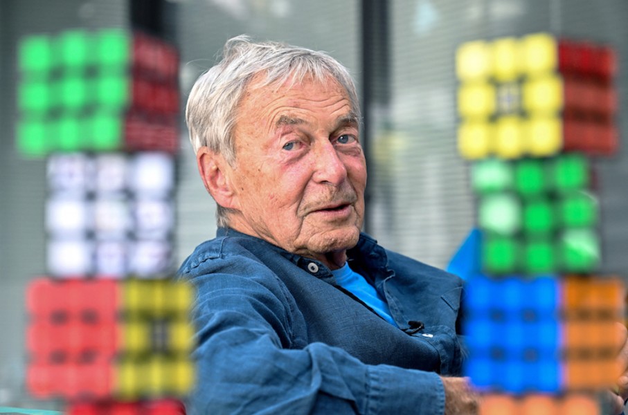 Hungarian inventor Erno Rubik sits next to several Rubik's Cubes. AFP/Attila Kisbenedek