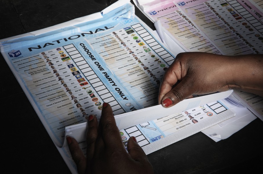 An Electoral Commission of South Africa (IEC) official prepares a ballot to be handed out to a voter. AFP/Gianluigi Guercia