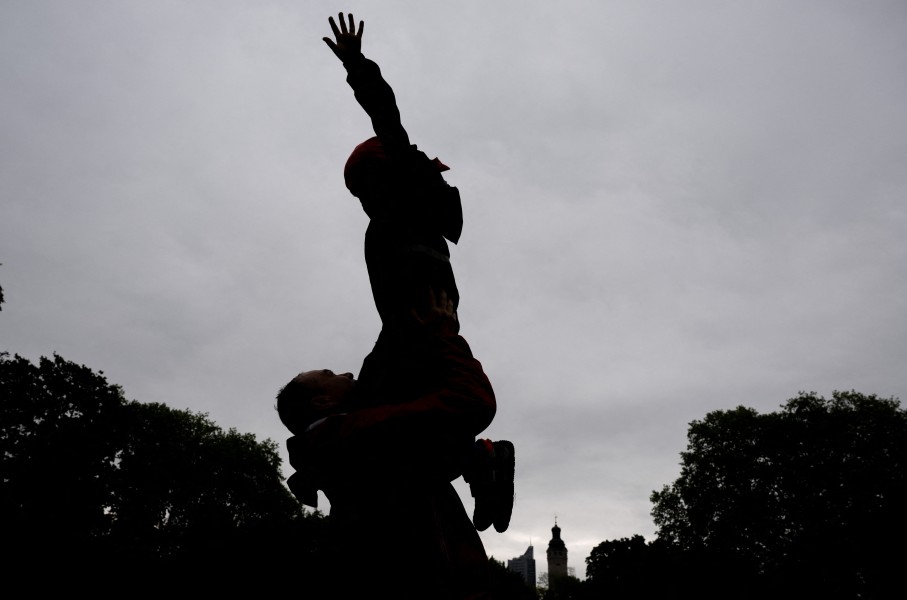 File: A father plays with his son in a park.