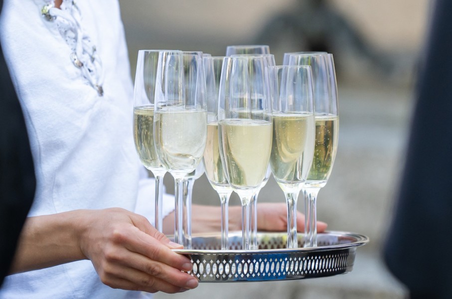 File: Glasses of sparkling wine are served on a tray. Silas Stein/dpa Picture-Alliance via AFP