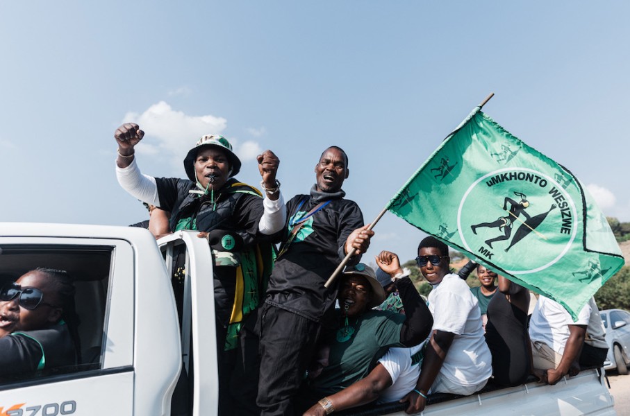 Supporters of the MK Party hold flags and chant slogans while celebrating. AFP/Rajesh Jantilal