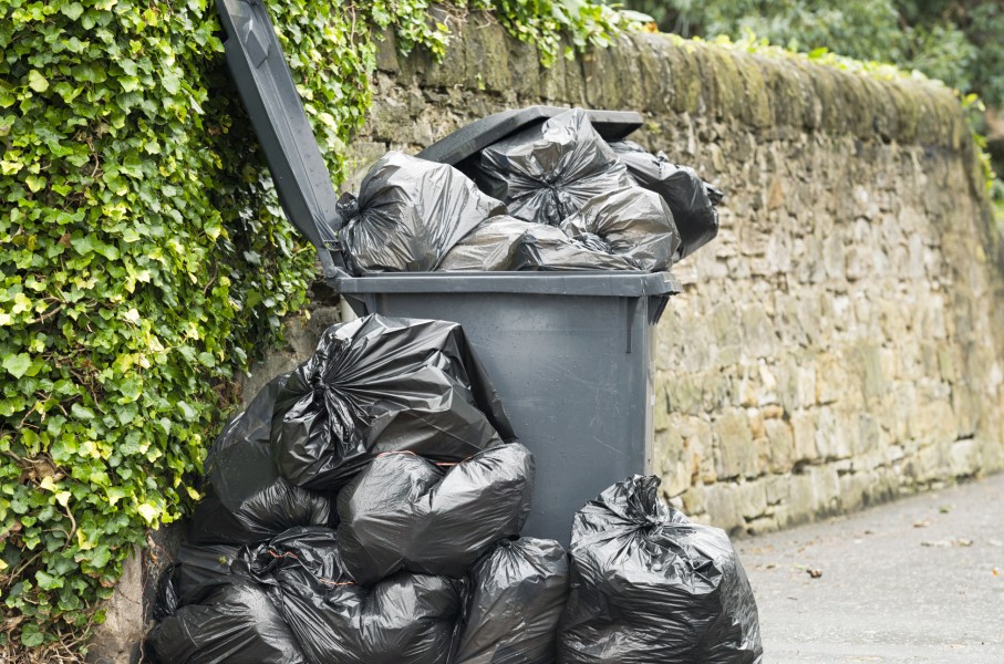 File: A full wheelie bin with rubbish bags overflowing. GettyImages/georgeclerk