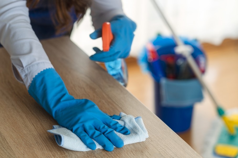 File: A domestic worker cleaning a desk. GettyImages/Dusan Sapic