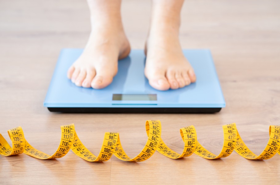 File: A person standing on a scale. Weight loss. GettyImages/Cunaplus_M.Faba