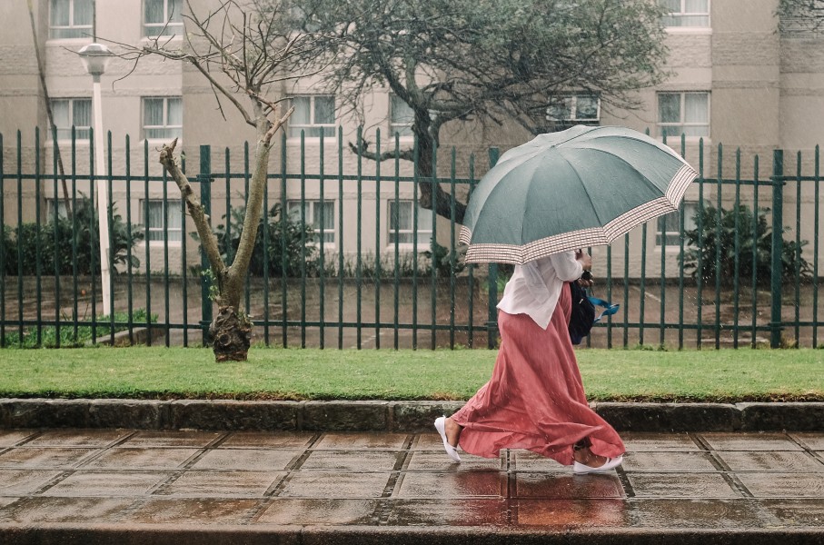 A woman walks through heavy rain in the city of Durban. AFP/Rajesh Jantilal