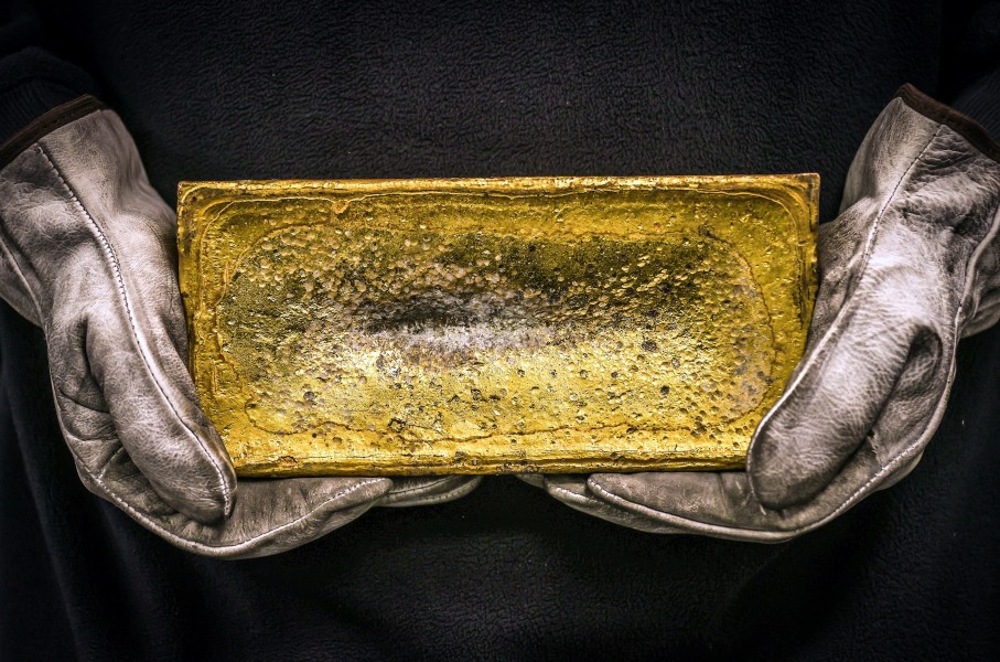 File: A miner holding a 20kg gold brick. AFP/David Gray