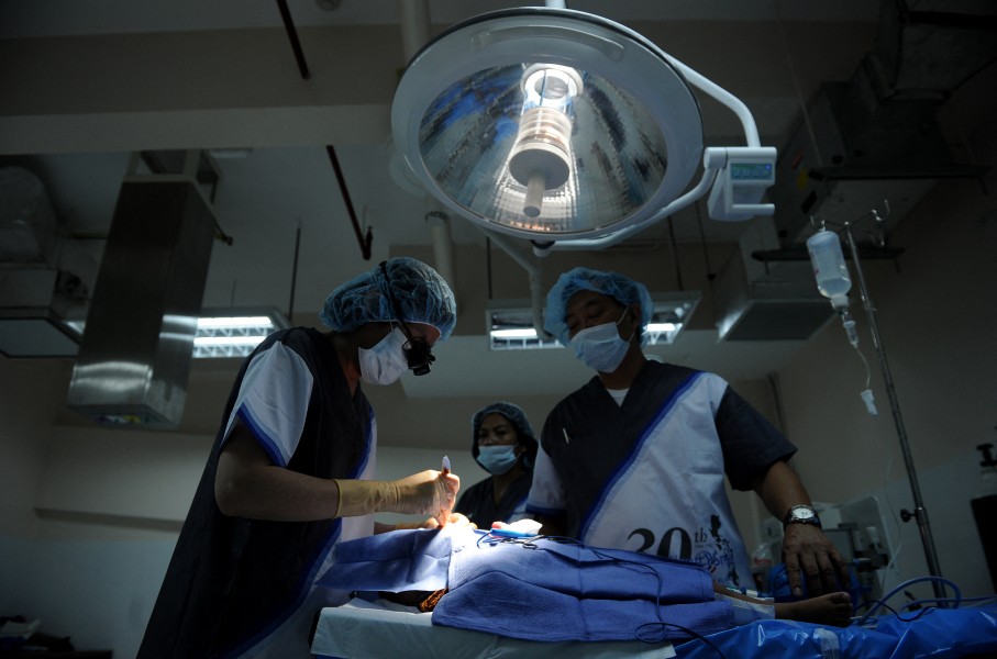 File: Doctors are pictured in the operating theatre as they perform surgery. AFP/Noel Celis