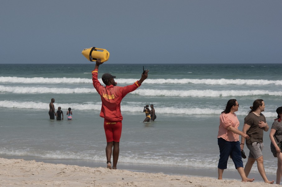 A lifeguard directs people to move into the swimming zone. AFP/Rodger Bosch