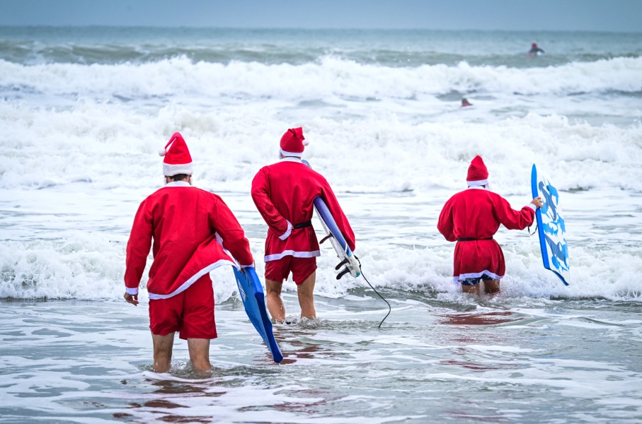 Surfers dressed as Santa Claus. AFP/Giorgio Viera