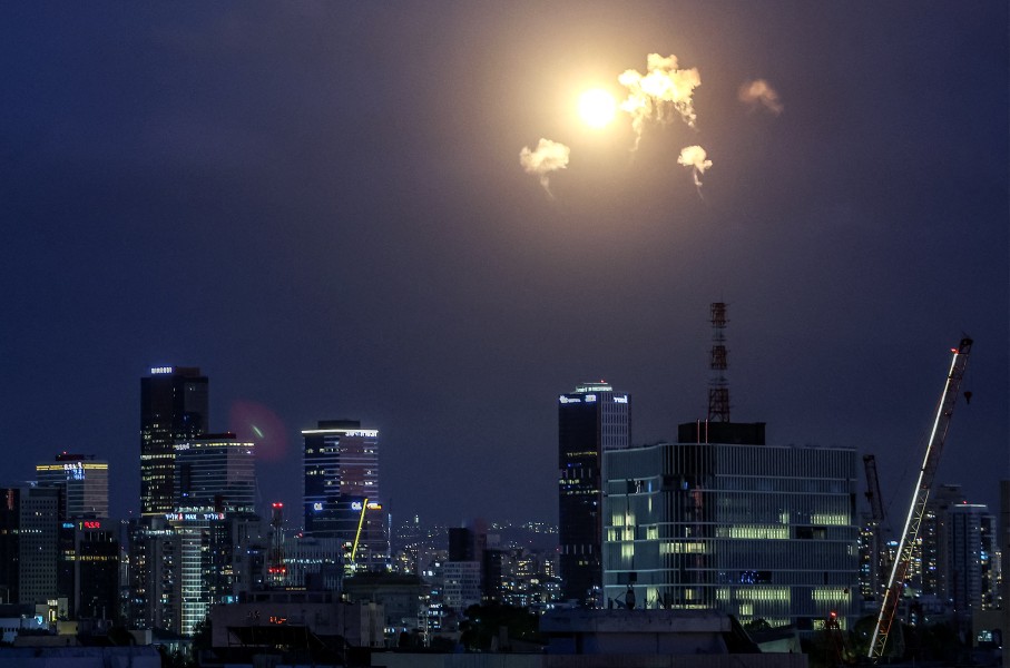 Explosions from projectile interceptions by Israel's Iron Dome missile defence system are pictured over Tel Aviv. AFP/Jack Guez