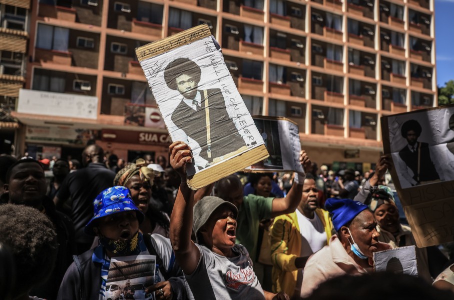 A protester holds a placard with Isaac Satlat's picture. Gallo Images/Phill Magakoe
