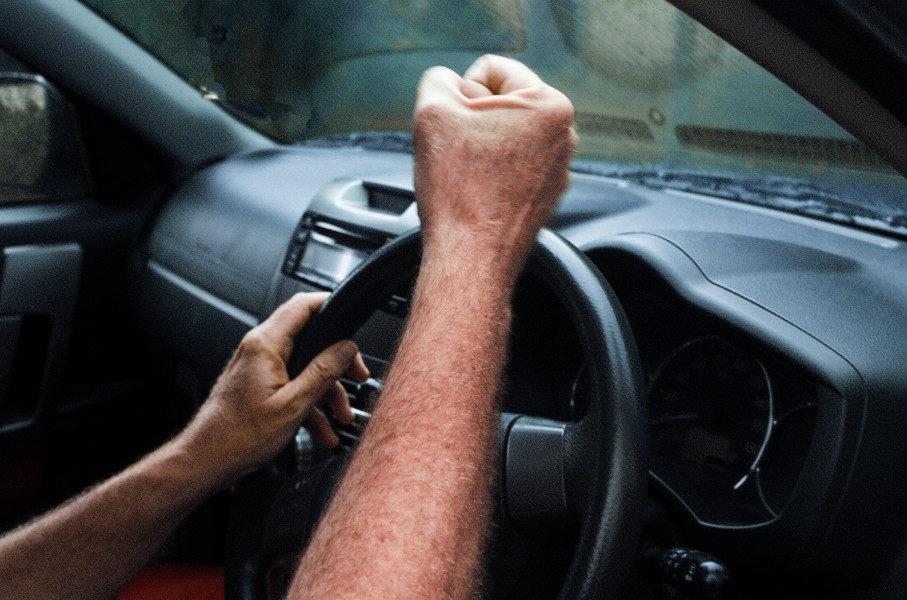 File: An angry car driver pulls a fist at another motorist. GettyImages/brazzo