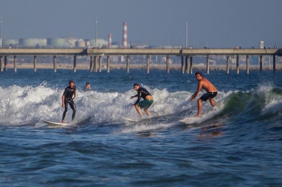 Surfers catch a wave at Venice Beach in Los Angeles, California. AFP/Apu Gomes
