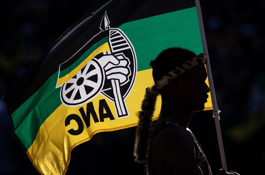 A performer holds an ANC flag while listening to President of the ruling African National Congress (ANC) and South African President, Cyril Ramaphosa speak during the ANC Siyanqoba Rally held at FNB Stadium on May 25, 2024 in Johannesburg, South Africa. South Africa's national and provincial elections will be held on 29 May 2024 to elect a new National Assembly and provincial legislature in each of the nine provinces. (Photo by Chris McGrath/Getty Images)