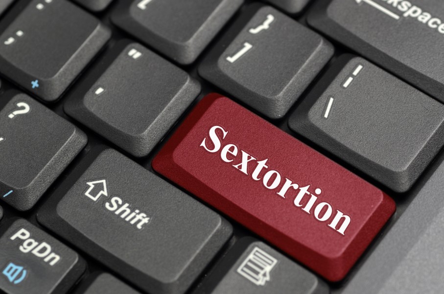 The word sextortion on a keyboard. GettyImages/payphoto