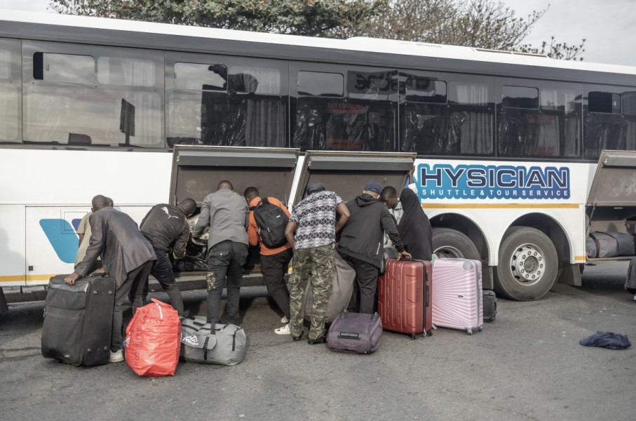 Documented foreign nationals pack their belonging in a bus in Durban for relocation to the Lindela Repatriation Centre in Gauteng. AFP/Rajesh Jantilal