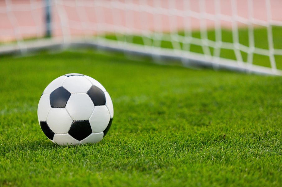 Closeup of a soccer ball and goalpost. GettyImages/artisteer