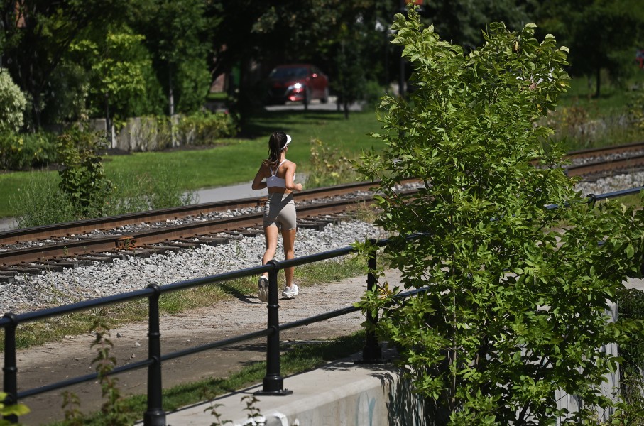 A woman jogs along a canal in Montreal, Quebec, Canada, on August 21, 2026. (Photo by Graham Hughes/NurPhoto via Getty Images)