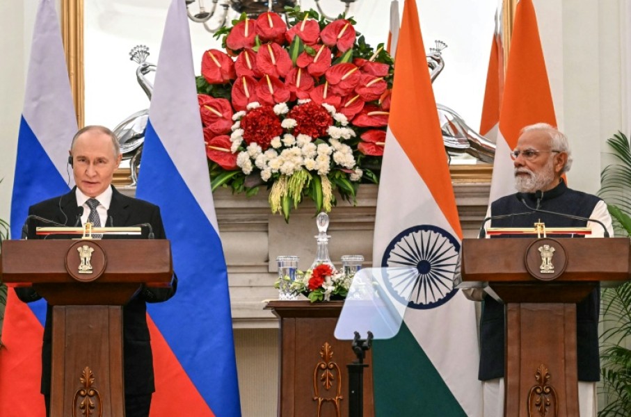 Russia's President Vladimir Putin (L) speaks as India's Prime Minister Narendra Modi listens during their joint press statements after their meeting at the Hyderabad House in New Delhi on December 5, 2025