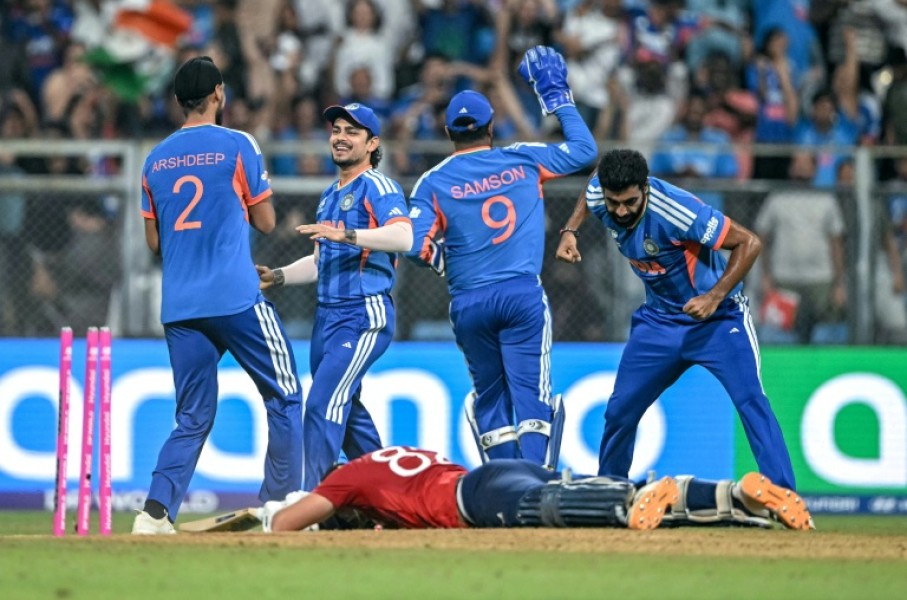 India's players celebrate after the run out of Jacob Bethell for 105 in the final over