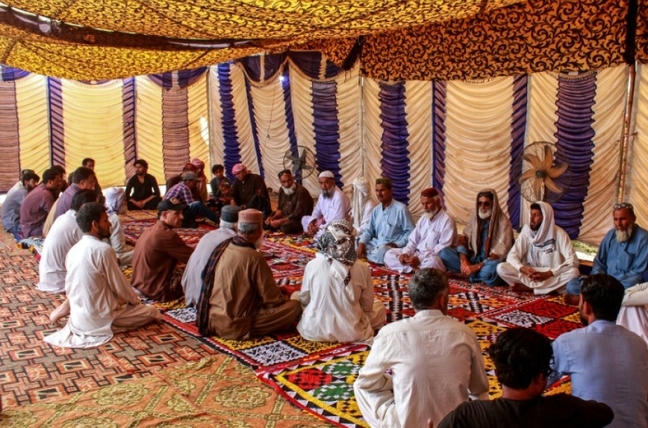 Mourners gather to offer condolences after the death of Pakistani national Muzaffar Ali, who was killed in Dubai amid the ongoing Middle East war, after his funeral in Jamshoro, in Sindh province