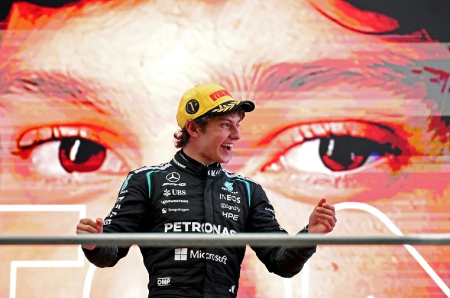 Kimi Antonelli celebrates on the podium after winning the Formula One Chinese Grand Prix