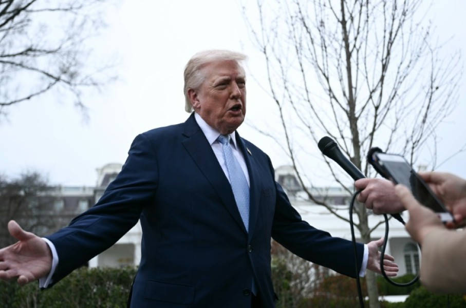 US President Donald Trump speaks to journalists before boarding Marine One as he departs from the South Lawn of the White House