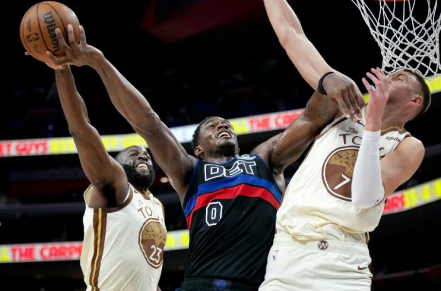 Golden State's Draymond Green blocks a shot attempt by Jalen Duren in the Warriors' NBA loss to the Detroit Pistons
