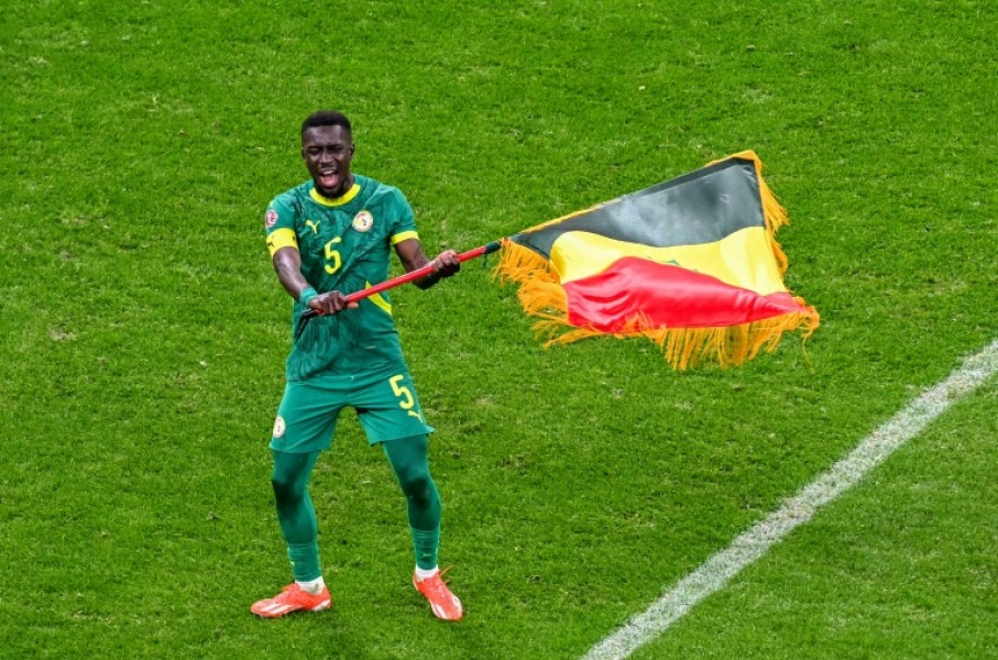 Idrissa Gueye waves the Senegal flag after his side beat Morocco on the field in the in the Africa Cup of Nations final in January