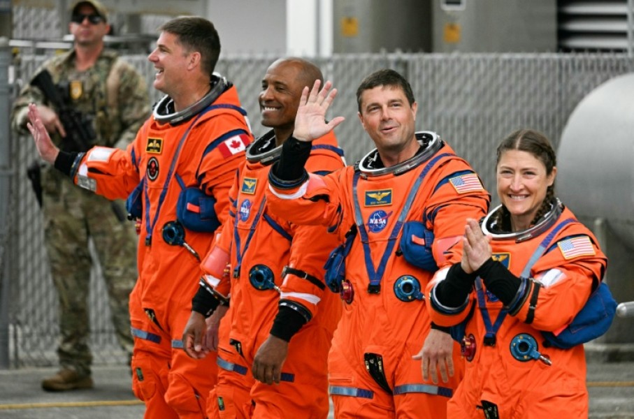 From left: Jeremy Hansen, Victor Glover, Reid Wiseman and Christina Koch heading toward the launch pad on Wednesday