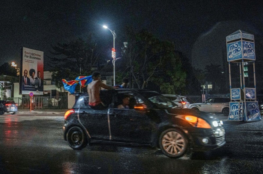 Congolese supporters celebrate in the rainy streets of Kinshasa