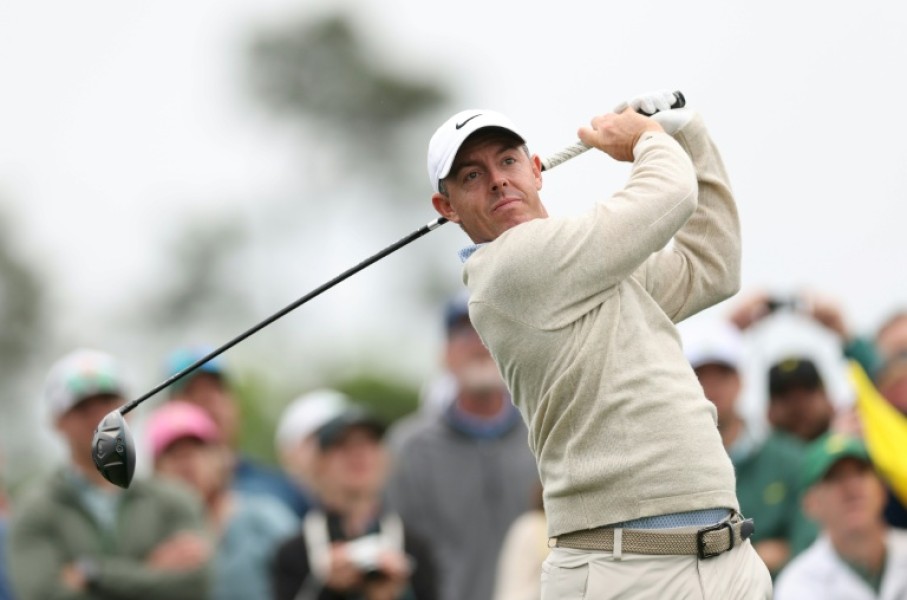 Defending champion and world number two Rory McIlroy of Northern Ireland plays a tee shot during a practice round for the 90th Masters at firm and fast Augusta National