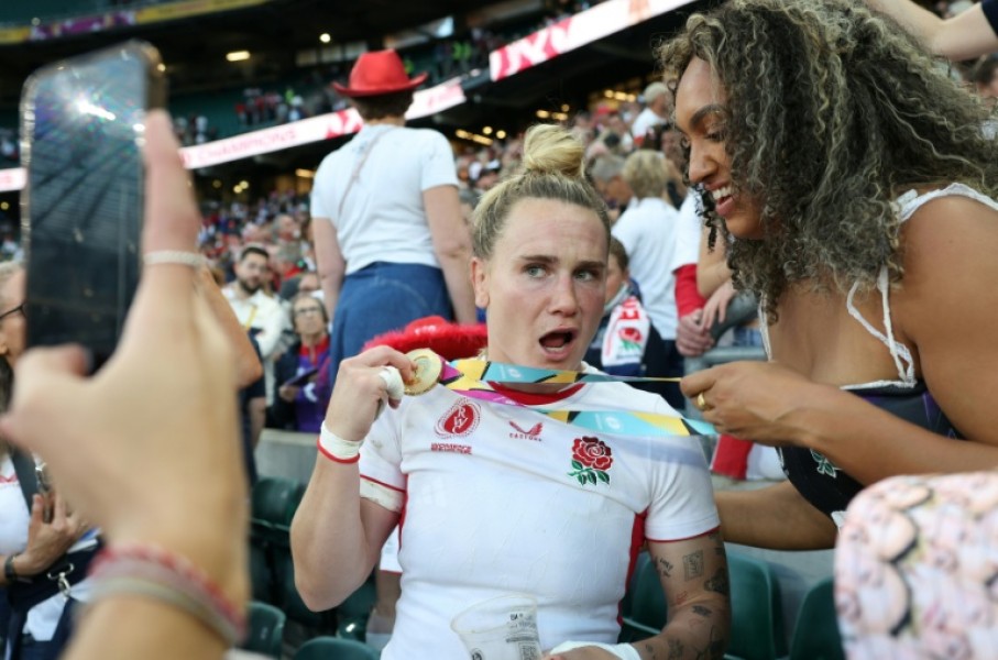 England centre Megan Jones (L) celebrates after their 33-13 Women's Rugby World Cup final win over Canada at Twickenham last year