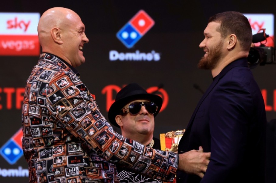 Britain's two-time former world heavyweight champion Tyson Fury (L) faces off with Russia's Arslanbek Makhmudov during a press conference ahead of their bout in London