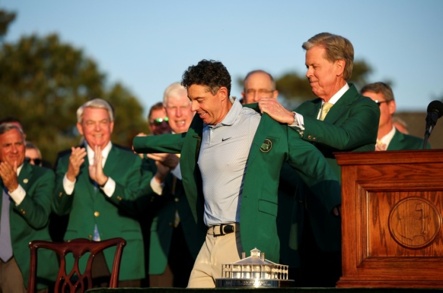 Rory McIlroy dons the green jacket after winning his second Masters in a row, forcing Augusta National chairman Fred Ridley to do the honor usually given to the prior year's champion