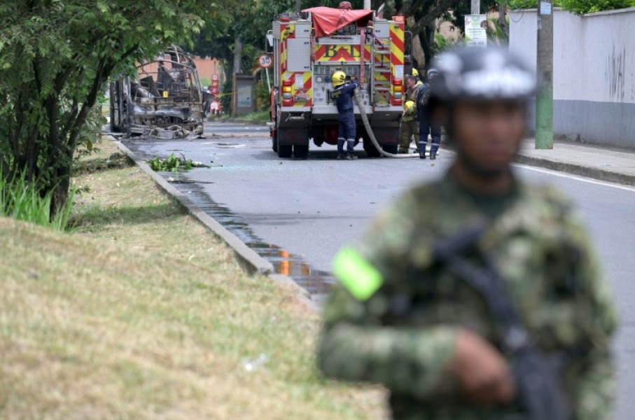 Colombian firefighters and soldiers deployed after a bomb explosion next to a military base in Cali