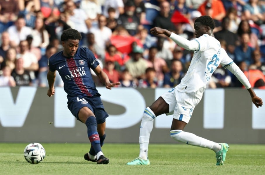 Ibrahim Mbaye (L) of Paris Saint-Germain and Abdoulaye Faye of Lorient fight for the ball.