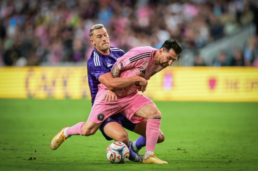 Inter Miami's Argentine forward, Lionel Messi, vies for the ball against Orlando City's Swedish defender Robin Jansson