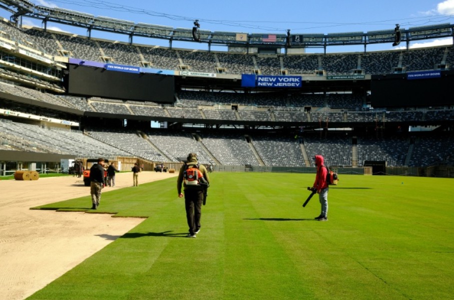 Pitch perfect: Workers install the pitch at New York New Jersey Stadium ahead of the 2026 FIFA World Cup