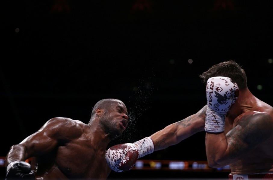 Daniel Dubois (L) takes a punch from champion Oleksandr Usyk during an undisputed world heavyweight title bout at London's Wembley Stadium in July last year