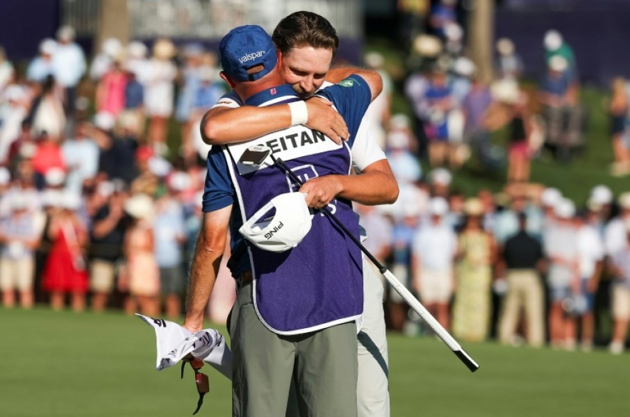 Norway's Kristoffer Reitan, back, hugs his caddie on the 18th green after winning his first US PGA Tour title at the Truist Championship at Quail Hollow