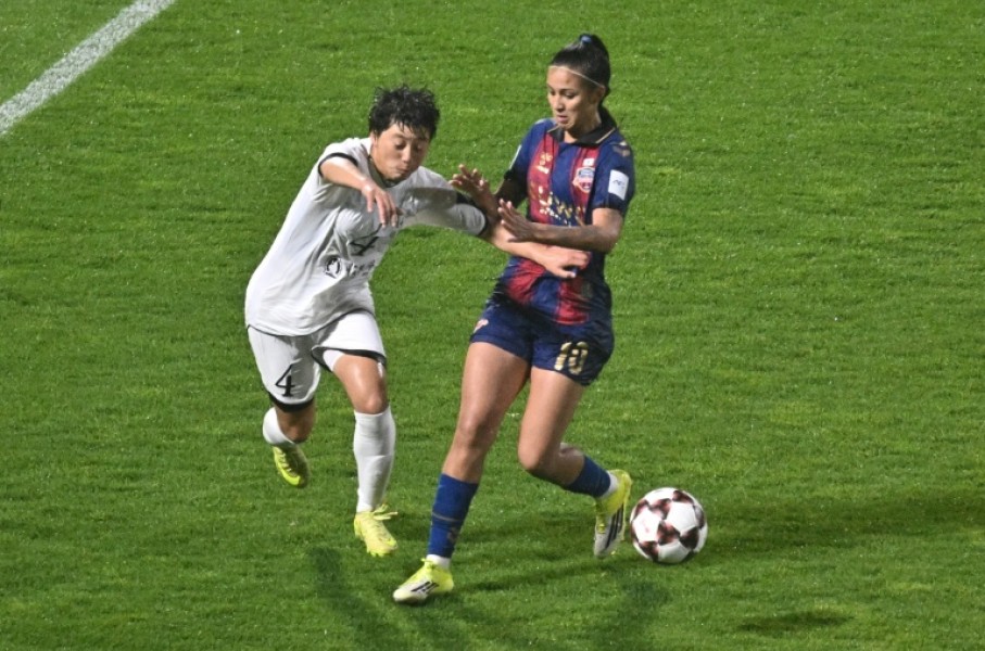 North Korea's Naegohyang Women's FC defender Ri Myong Gum (left) vies for the ball with South Korea's Suwon FC Women forward Mileninha Barreto de Oliveira during their Women's Asian Champions League semi-final at Suwon Sports Complex