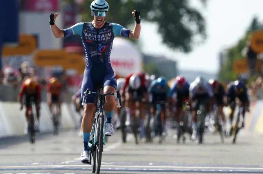 Alec Segaert celebrates as he crosses the line just ahead of the chasing pack
