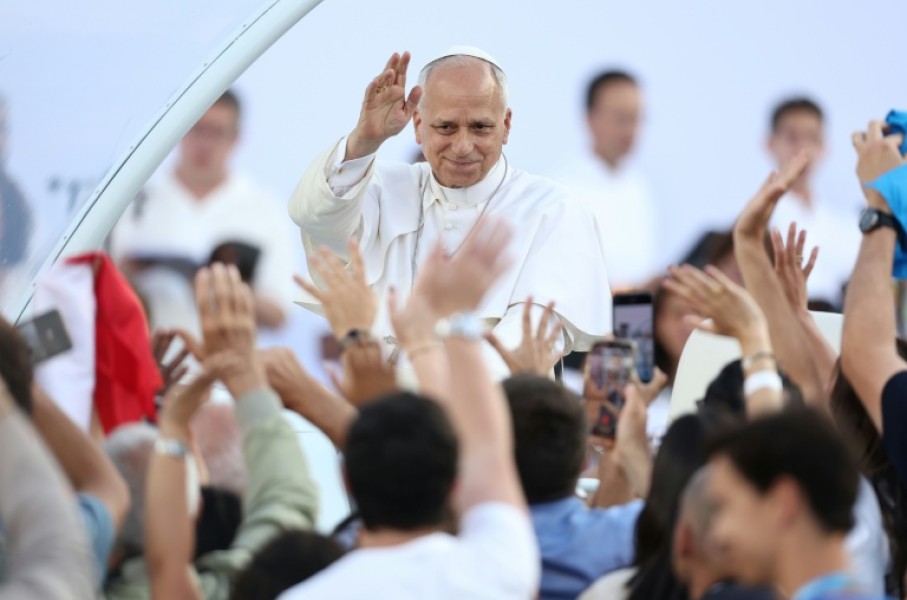 Pope Leo XIV greets the crowd as he arrives to attend a prayer vigil at the Olympic Stadium in Barcelona on June 9